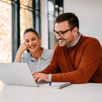 Two people working on laptop teamwork