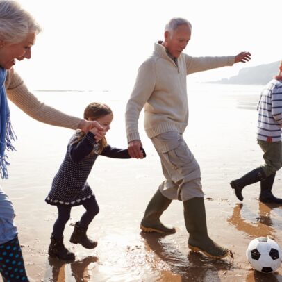 grandparents and grandchildren playing on the beach